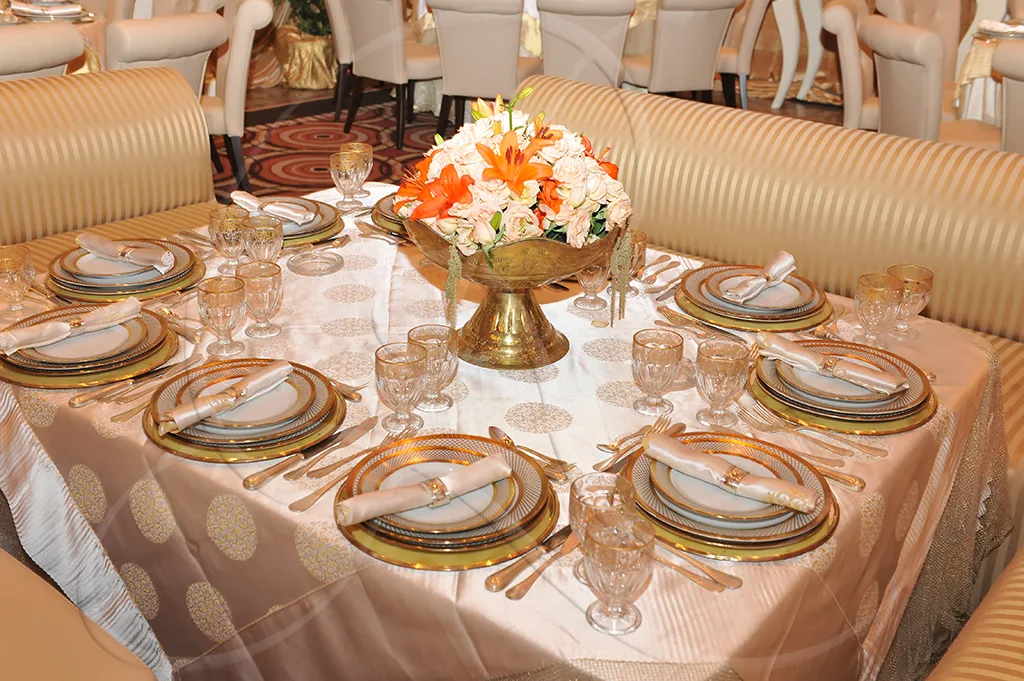 Gold damask tablecloth with orange flower arrangement in bronze bowl, family dinner, Rahal Maître Traiteur