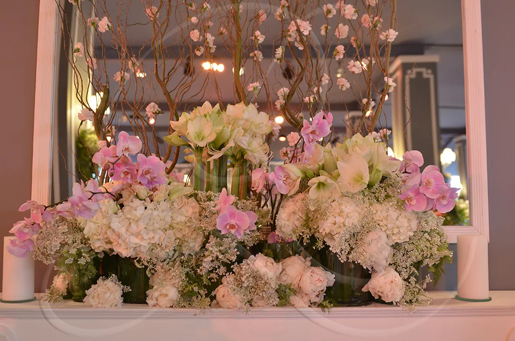 Orchid and peony floral arrangement on a mantelpiece in a residential interior, Rahal Maître Traiteur