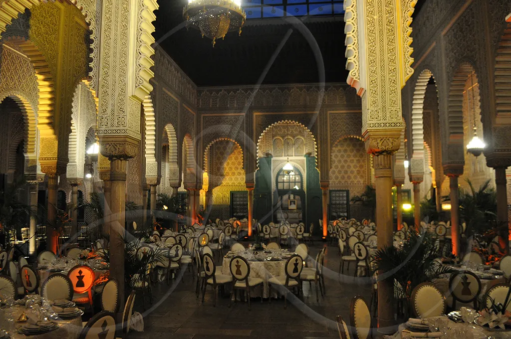 Corporate gala dinner in a grand reception hall, round tables set for service, Rahal Maître Traiteur, Casablanca