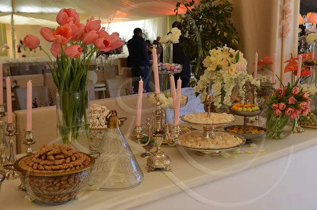 Oriental pastry buffet with pink tulips and silver candlesticks, private reception, Rahal Maître Traiteur
